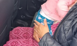 Toddler found asleep on passenger&#039;s lap with no seatbelt