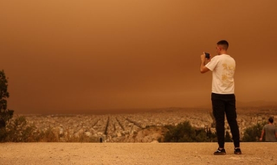 Skies over Athens turn &#039;apocalyptic&#039; orange from Sahara dust storm - while Libya has red haze